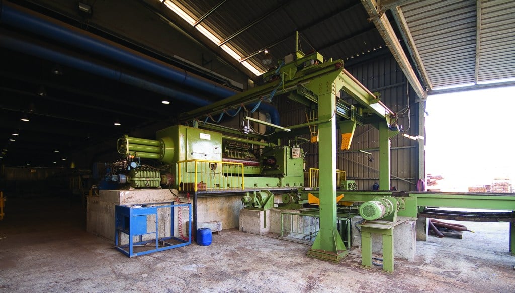 Log processing machinery and a material conveyor inside the Bahar production facility