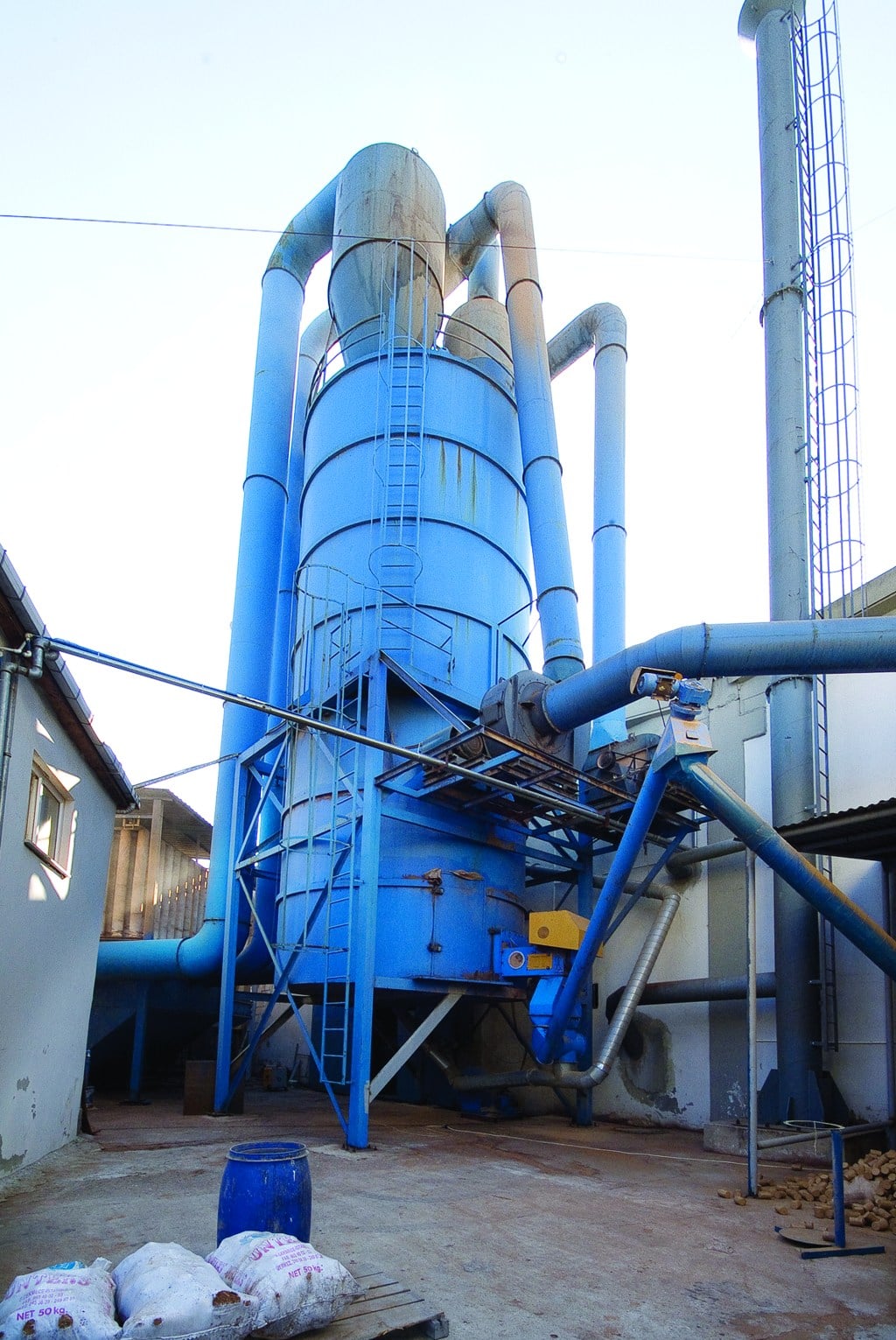 A blue silo and pipes connected to the Bahar facility’s drying and energy systems