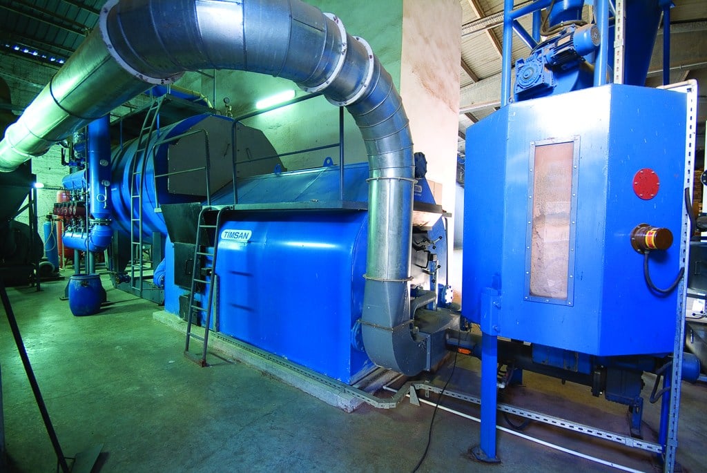 Blue biomass energy equipment and metal pipes in the Bahar facility’s boiler room